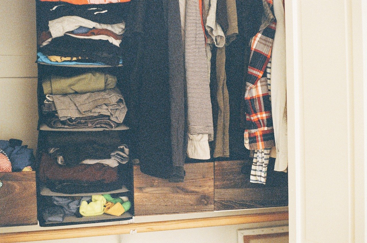 messy closet with hanging organizer